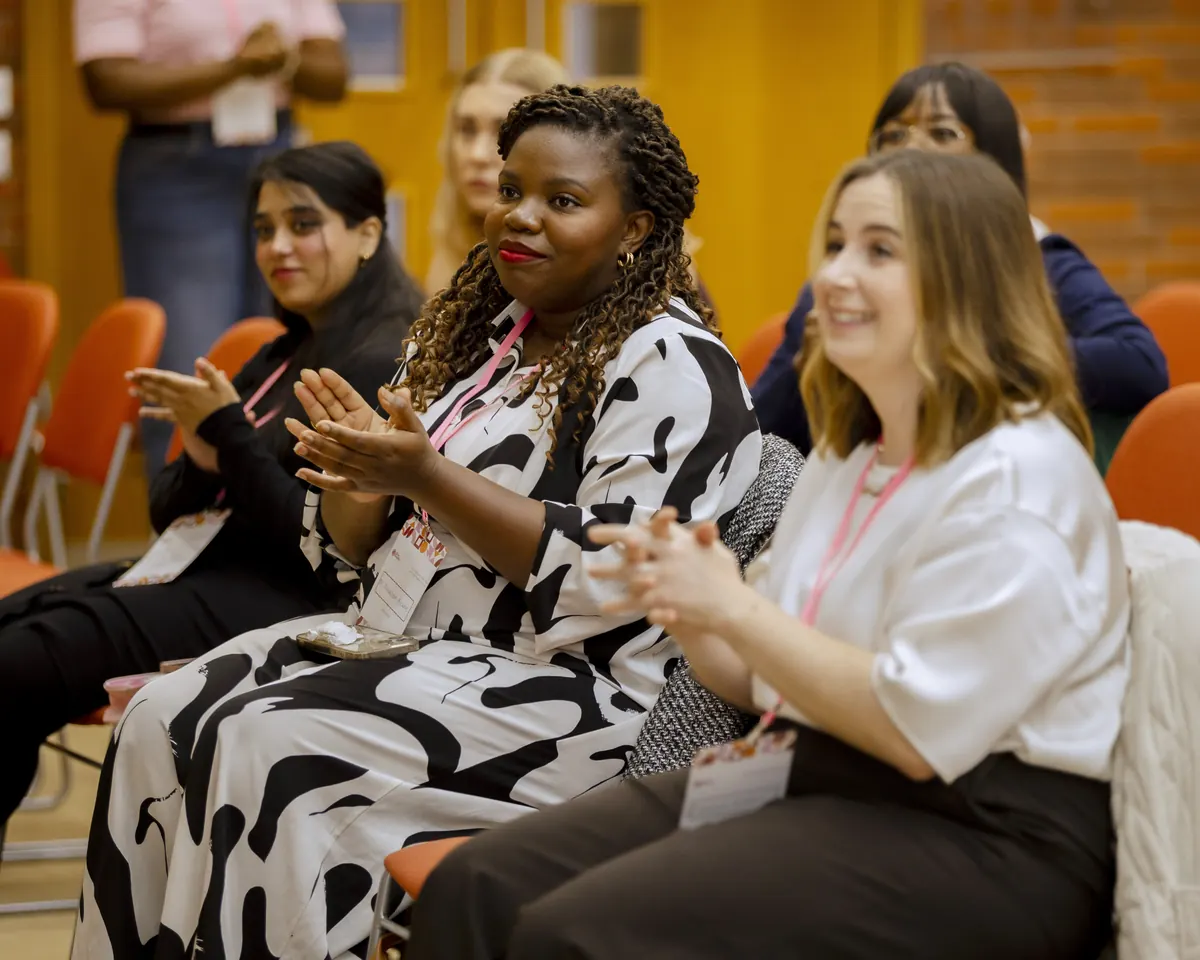 Attendees applauding during a session at the summit