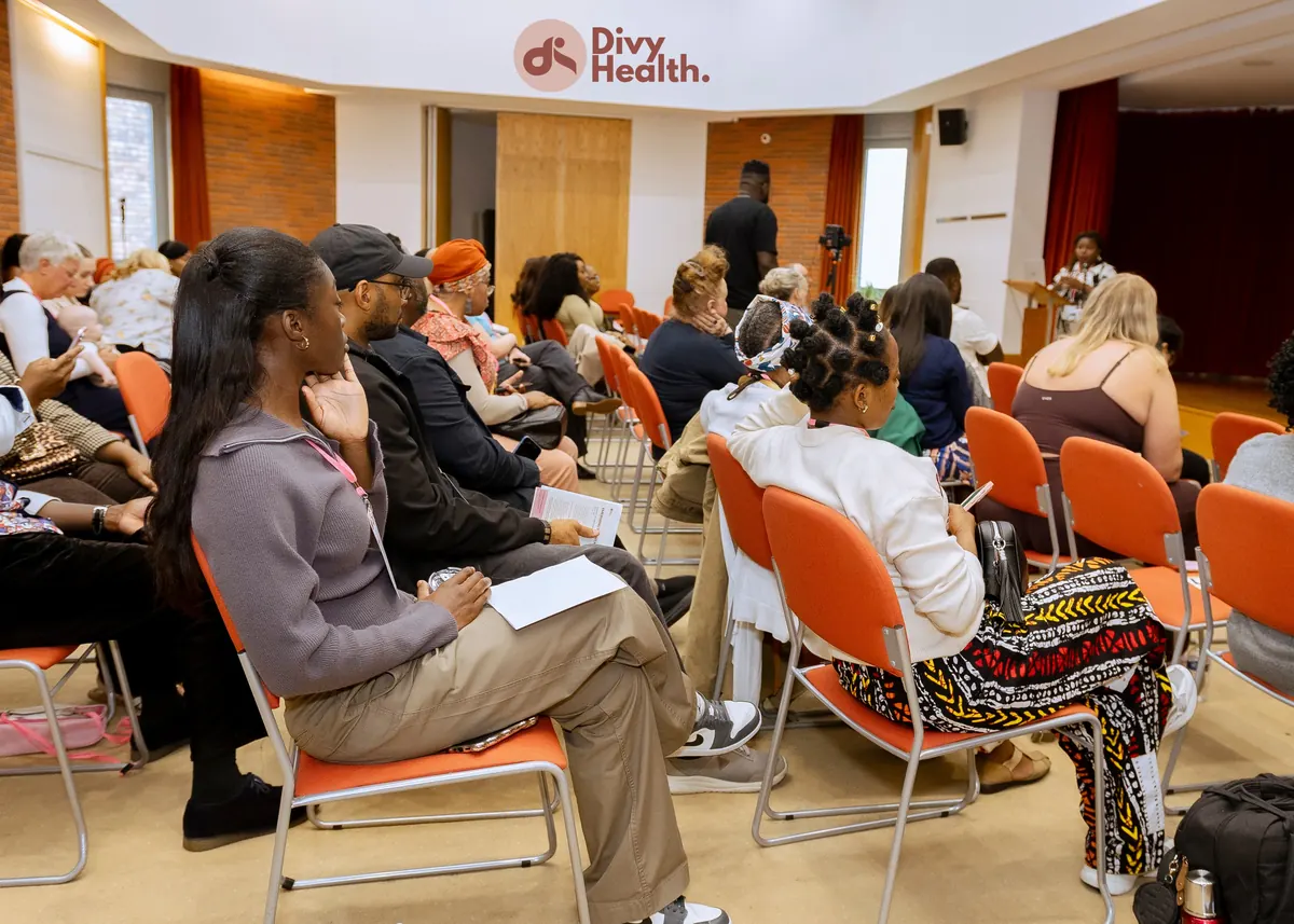 Attendees seated and listening to a speaker at the summit